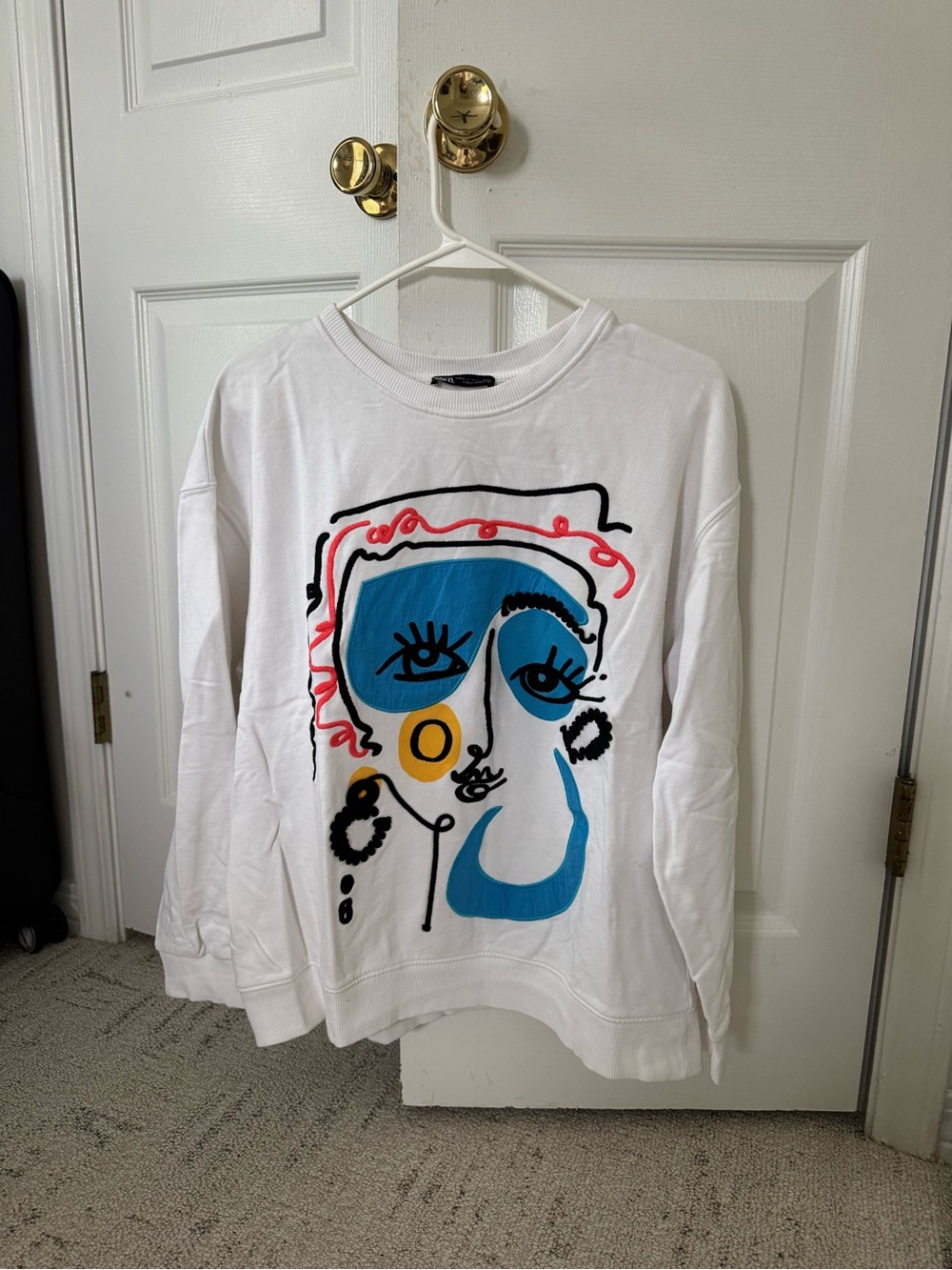 Zara White Graphic Sweatshirt with Blue, Yellow & Pink Face Design